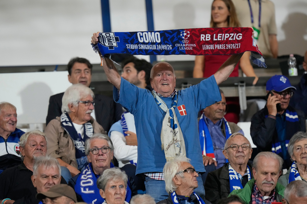 Como older fan cheers prior to the start of the Champions League opening phase soccer match between Como and Leipzig in Como, Italy, Thursday, Sept. 10, 2026, Como officials giving up seats to older fans. (AP Photo/Luca Bruno)