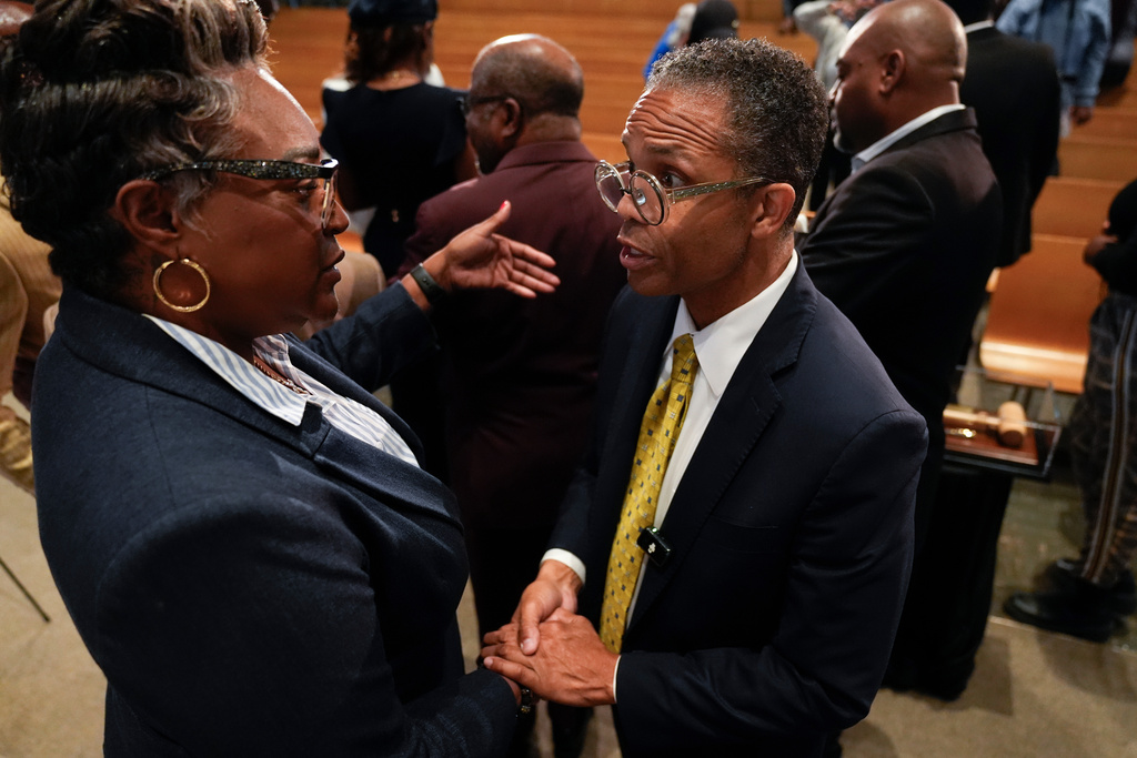 Former Illinois Rep. Jesse Jackson Jr., right, speaks to Knitasha Washington during an event where he was endorsed by the Southland Minister Alliance as a candidate for his old congressional seat after more than a decade out of office, Oct. 15, 2025, at Victory Christian International Ministries in Park Forest, Ill. (AP Photo/Erin Hooley)