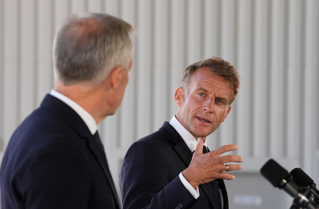 French President Emmanuel Macron, right, looks to Canadian Prime Minister Mark Carney as he delivers remarks in Saint-Pierre, Saint-Pierre-et-Miquelon, Sunday, Sept.20, 2026. (Adrian Wyld/The Canadian Press via AP)