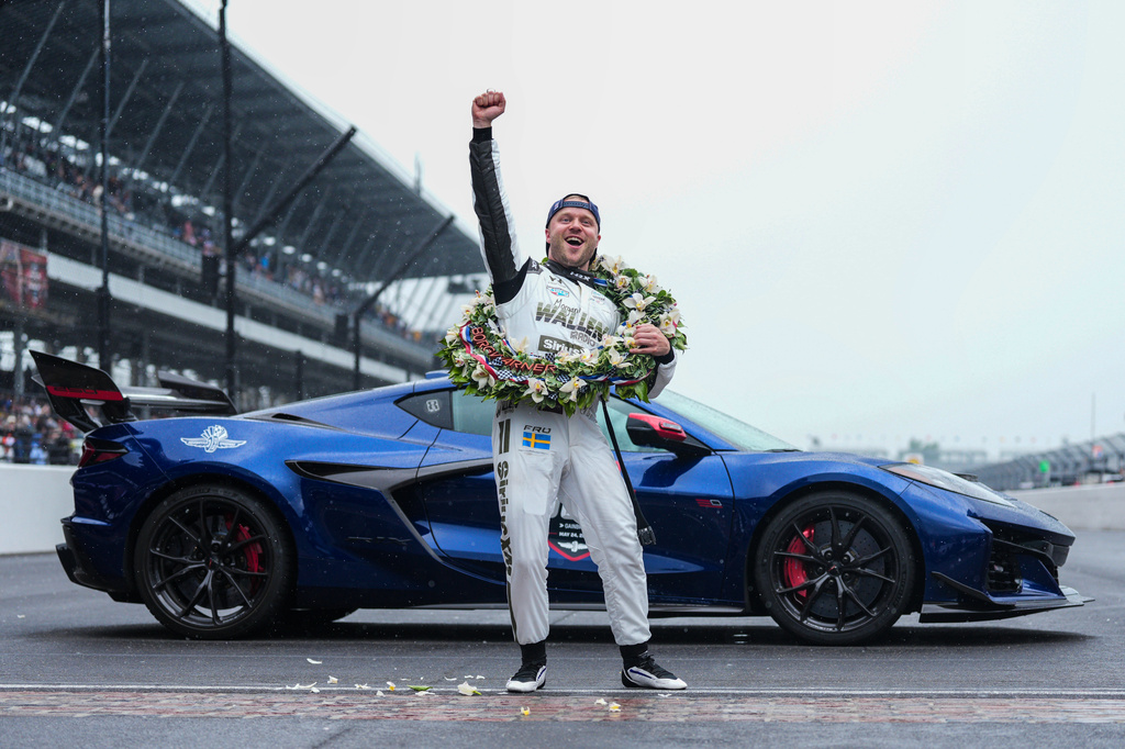 Felix Rosenqvist, of Sweden, pumps his fist at the request of track officials after winning the Indianapolis 500 auto race at Indianapolis Motor Speedway, Sunday, May 24, 2026 in Indianapolis. (AP Photo/AJ Mast)