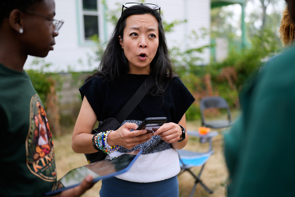 Democratic gubernatorial candidate Francesca Hong talks with Milwaukee residents during "We Outside" Annual Community Event at Metcalfe Park Rising, Friday, July 24, 2026, in Milwaukee. (AP Photo/Nam Y. Huh)