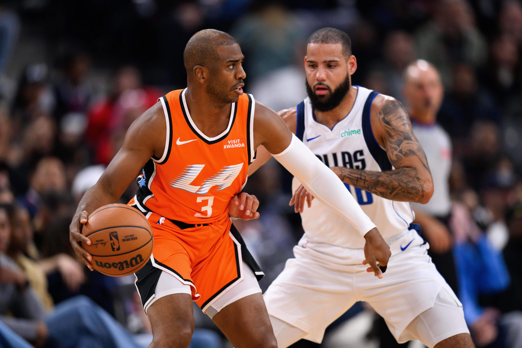 Los Angeles Clippers guard Chris Paul (3) controls the ball under pressure from Dallas Mavericks forward Caleb Martin during the first half of an NBA basketball game Saturday, Nov. 29, 2025, in Inglewood, Calif. (AP Photo/William Liang)
