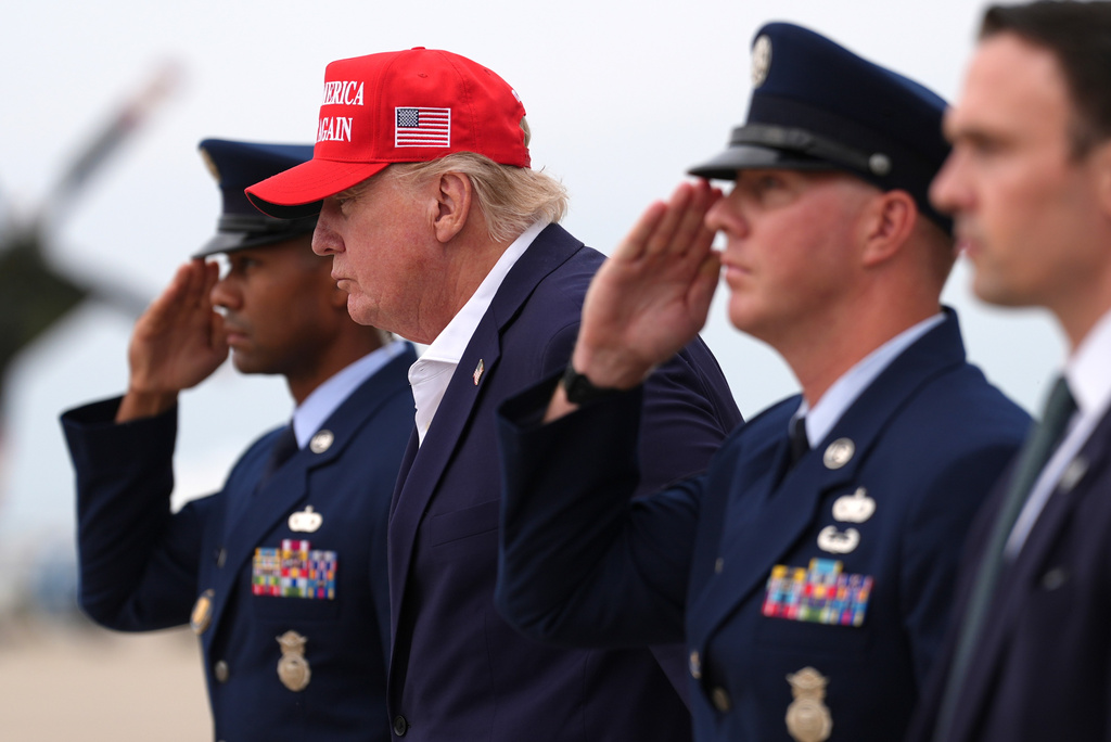 President Donald Trump, second left, walks to board Marine One, Sunday, Aug. 16, 2026, at Joint Base Andrews, Md. (AP Photo/Julia Demaree Nikhinson)