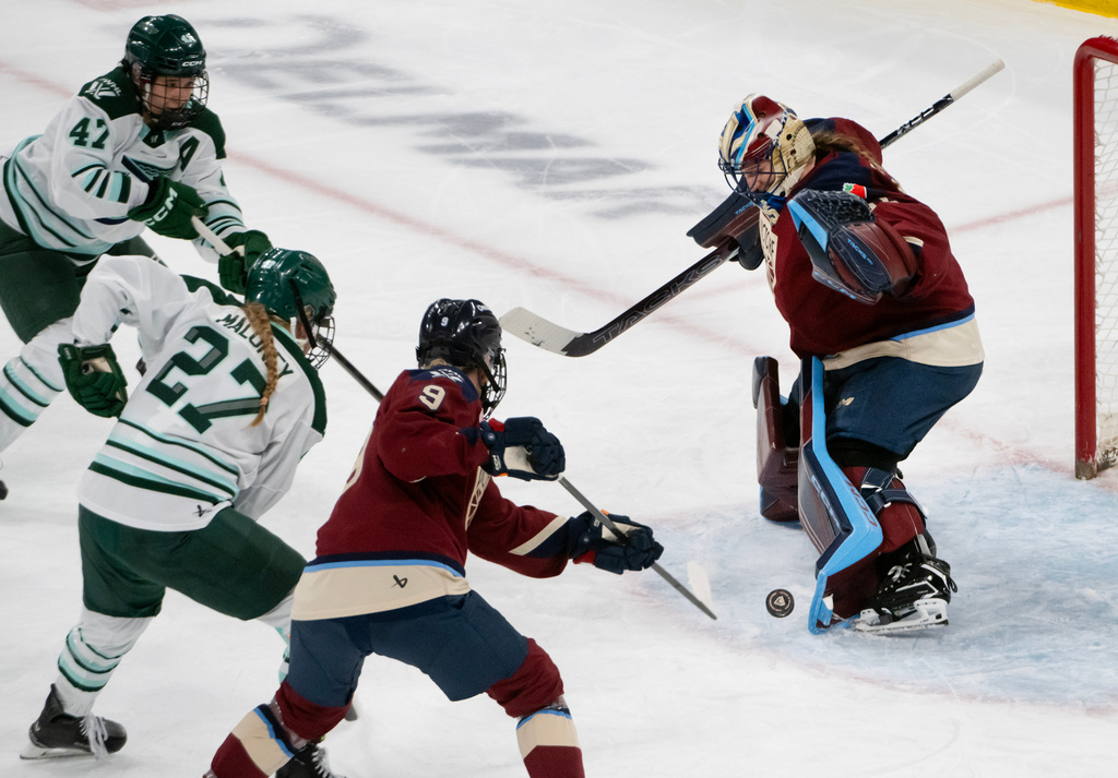 Montreal Victoire goaltender Ann-Renee Desbiens, right, deflects a shot off her pads during third-period PWHL hockey game action against the Boston Fleet in Laval, Quebec, Sunday March 15, 2026. (Peter McCabe/The Canadian Press via AP)