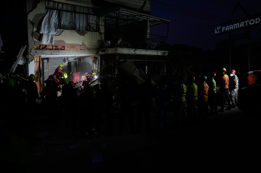 Rescuers from Argentina search a building damaged by back-to-back earthquakes after residents reported hearing noises from beneath the rubble in Catia La Mar, Venezuela, Wednesday, July 1, 2026. (AP Photo/Fernando Vergara)