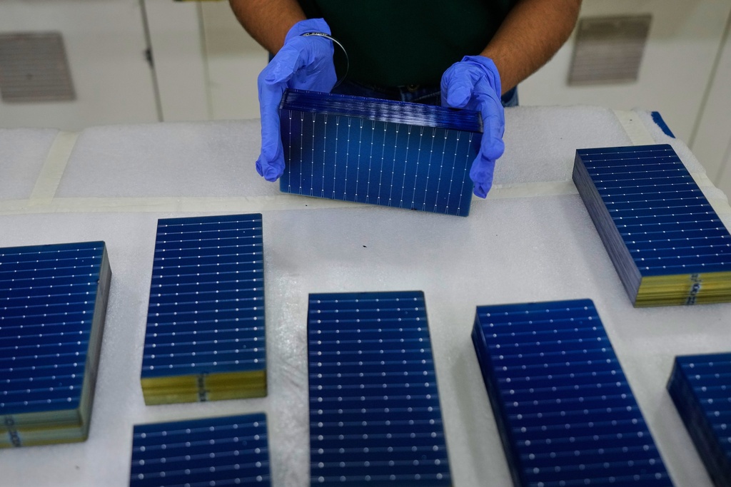 FILE - A worker stacks solar cells in a ReNew manufacturing plant on the outskirts of Jaipur, India, Thursday, Aug. 21, 2025. (AP Photo/Manish Swarup, File)
