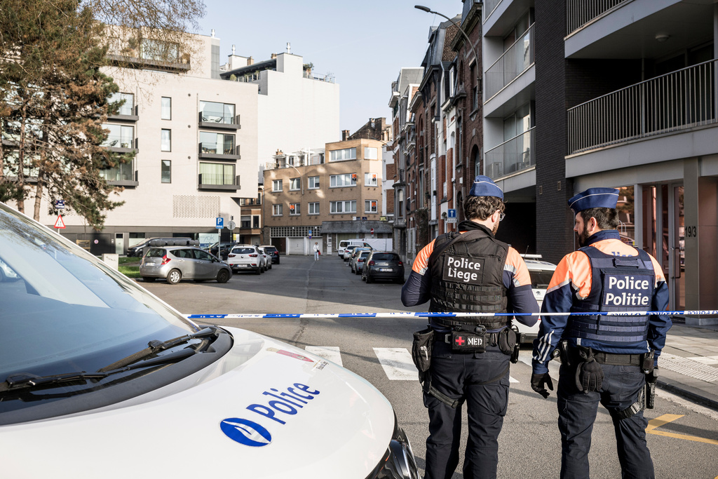 Police stand near barricades as they secure an area after a blast took place near a synagogue, in Liege, Belgium, Monday, March 9, 2026. (AP Photo/Valentin Bianchi)