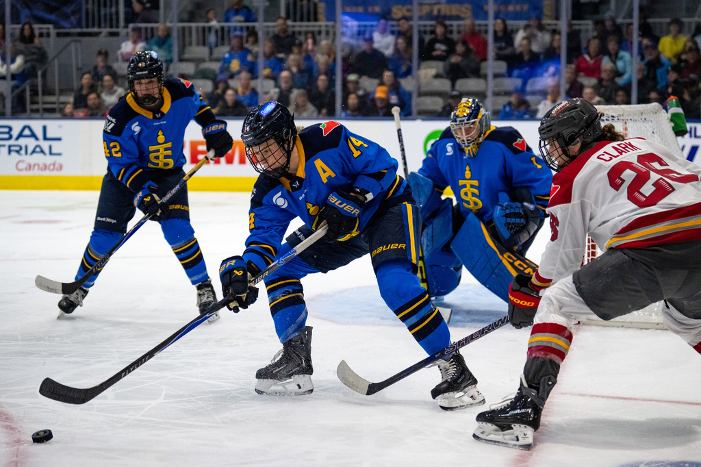 FILE - Toronto Sceptres' Renata Fast (14) takes the puck from Ottawa Charge forward Emily Clark (26) during the first period of a PWHL hockey game in Toronto, April 11, 2026. (Arlyn McAdorey/The Canadian Press via AP, File)