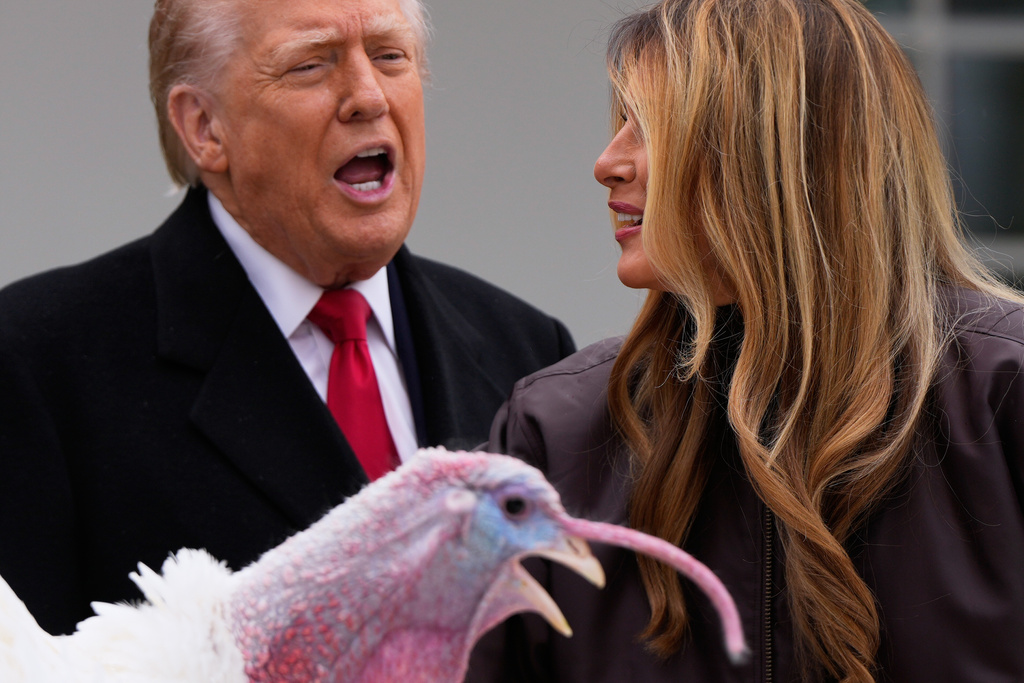 President Donald Trump and first lady Melania Trump, stand next to national Thanksgiving turkey Gobble during a pardoning ceremony in the Rose Garden of the White House, Tuesday, Nov. 25, 2025, in Washington. (AP Photo/Julia Demaree Nikhinson)