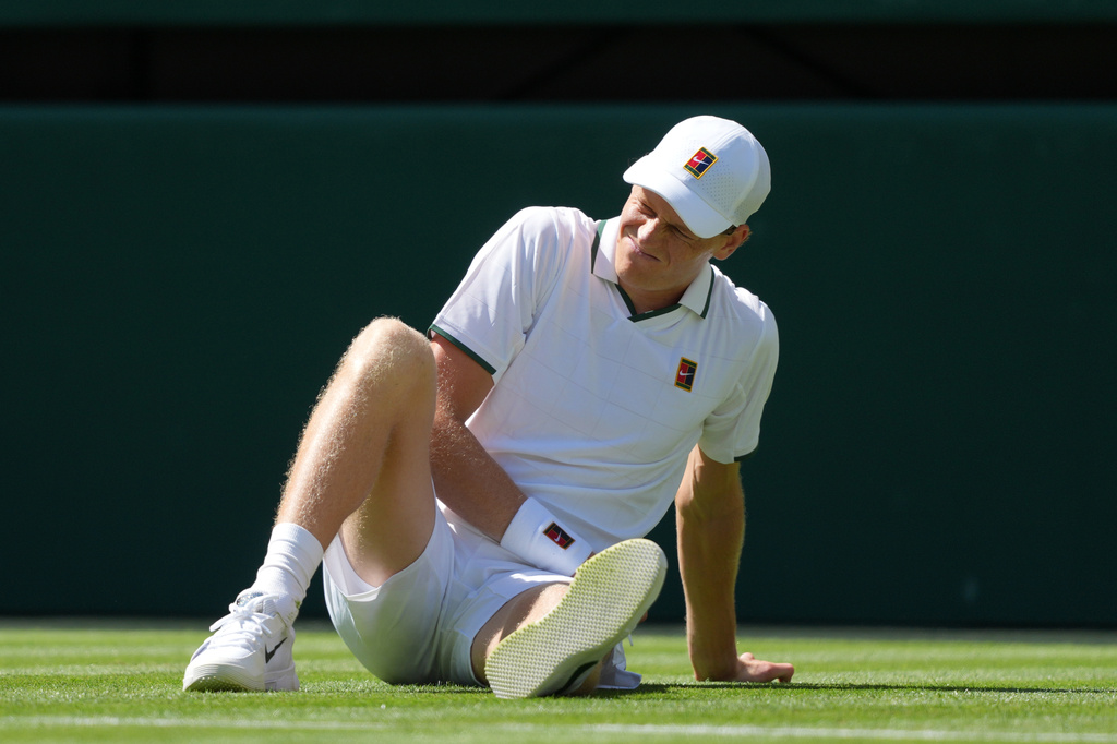 Jannik Sinner of Italy reacts as after falling over during the men's singles match against Miomir Kecmanovic of Serbia at the Wimbledon Tennis Championships in London, Monday, June 29, 2026.(AP Photo/Kin Cheung)