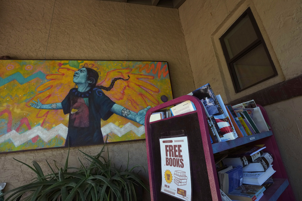 A free books trolley sits in front of Palabras Bilingual Bookstore, Monday, Oct. 6, 2025, in Phoenix. (AP Photo/Ross D. Franklin)