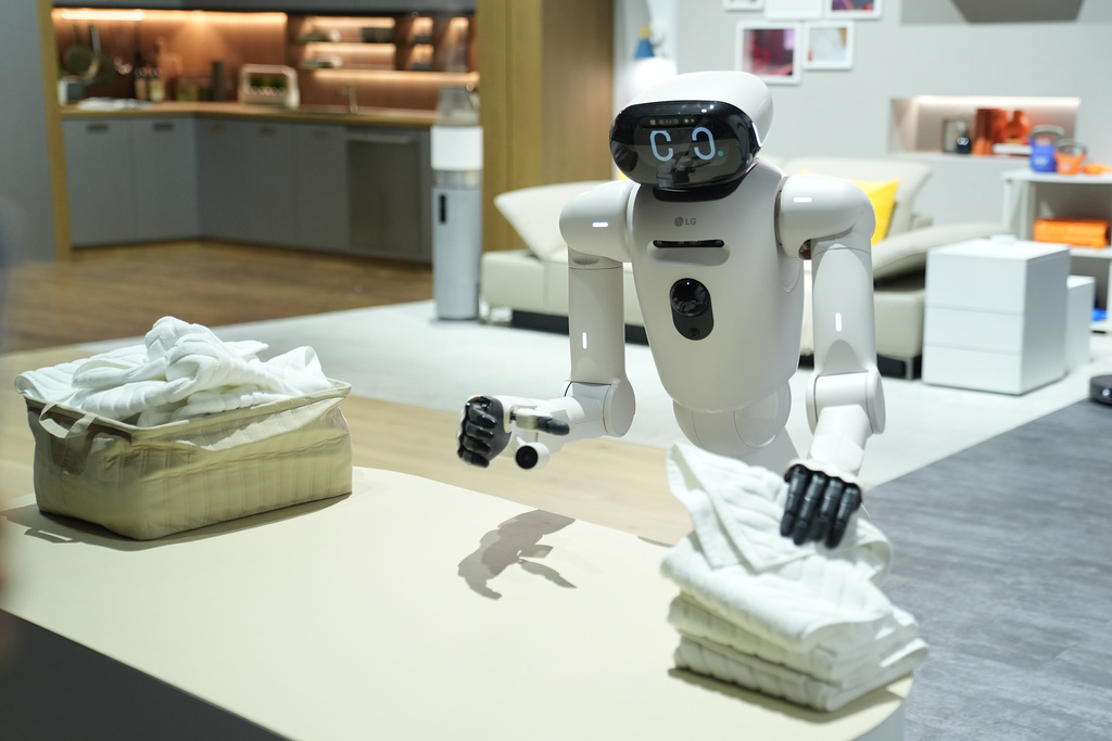 An LG CLOiD robot folds laundry at the LG Electronics booth during the CES tech show Tuesday, Jan. 6, 2026, in Las Vegas. (AP Photo/Abbie Parr)