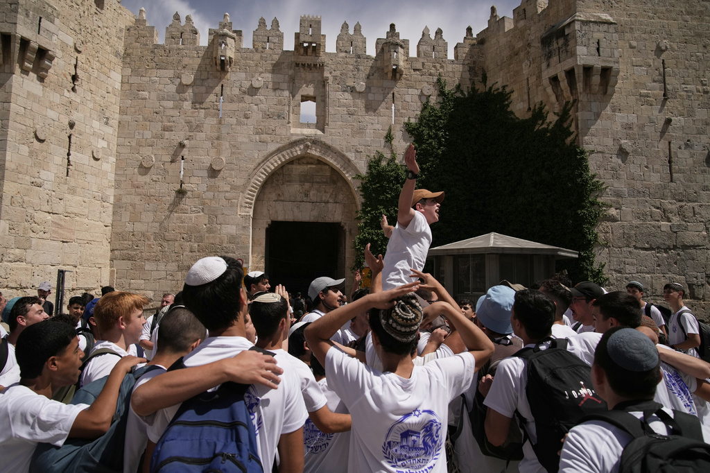 Israeli youth celebrate in Damascus Gate ahead of a march marking Jerusalem Day, an Israeli holiday celebrating the capture of east Jerusalem in the 1967 Mideast war, in Jerusalem's Old City, Thursday, May 14, 2026.(AP Photo/Leo Correa)