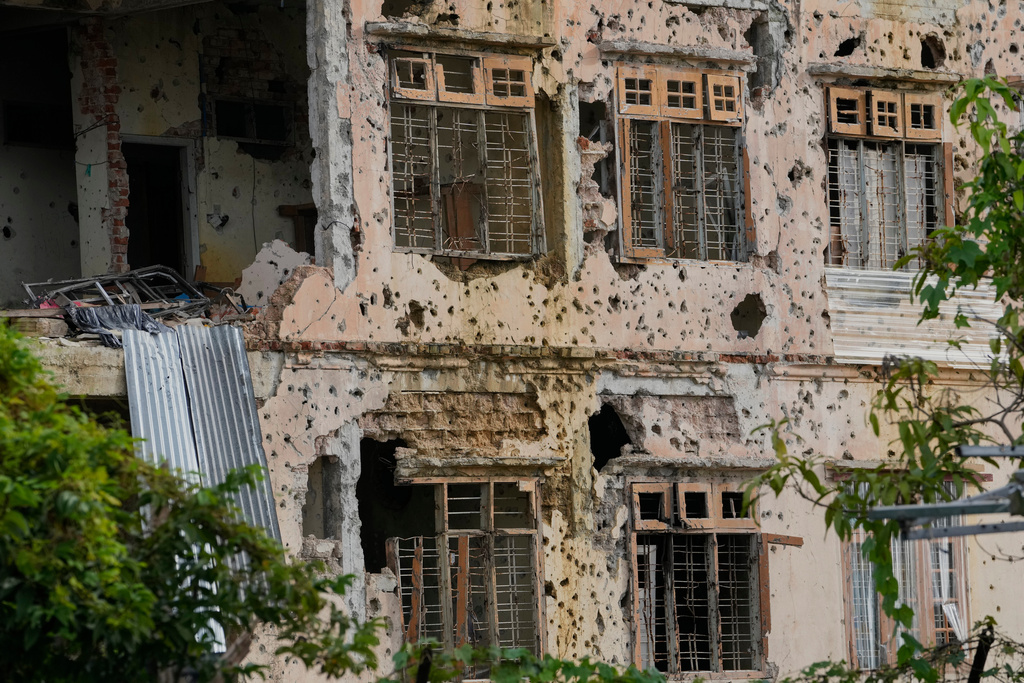 In this photo taken during a trip supervised by pro-military Myanmar media, a damaged residence is seen in Kawnghkio township, northern Shan State, Myanmar, Friday, Oct. 10, 2025. (AP Photo/Aung Shine Oo)