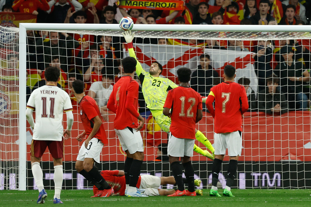 Egypt's goalkeeper Mostafa Shobeir saves during the international friendly soccer match between Spain and Egypt in Barcelona, Spain, Tuesday, March 31, 2026. (AP Photo/Joan Monfort)