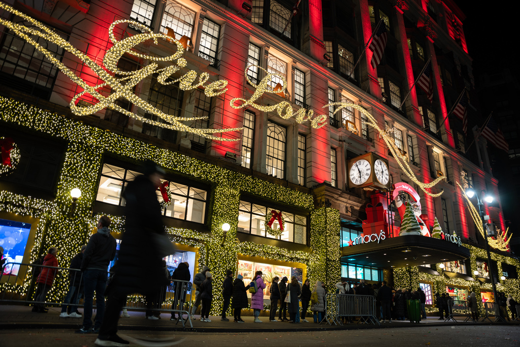 FILE - Shoppers wait in line to enter Macy's flagship store on Friday, Nov. 28, 2025 in New York. (AP Photo/Angelina Katsanis, File)