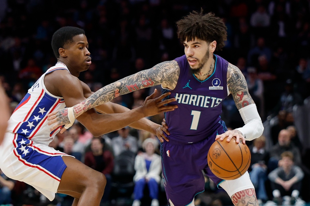 Charlotte Hornets guard LaMelo Ball (1) drives against Philadelphia 76ers guard V.J. Edgecombe during the first half of an NBA basketball game in Charlotte, N.C., Monday, Jan. 26, 2026. (AP Photo/Nell Redmond)