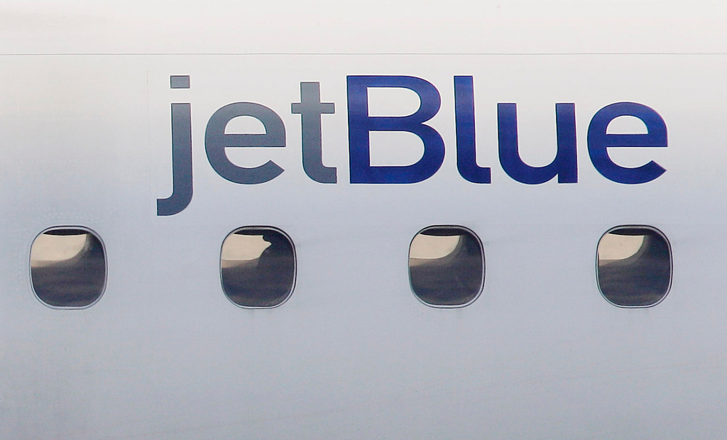 FILE - A JetBlue logo is displayed on the side of a jet as it taxis at Boston's Logan International Airport, Jan. 20, 2011. (AP Photo/Stephan Savoia, File)
