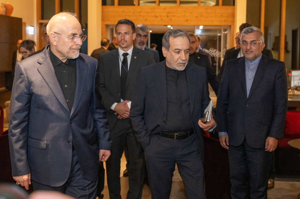Iranian Foreign Minister Seyyed Abbas Araghchi, center, and Speaker of the Islamic Parliament of Iran Mohammed Bagher Ghalibaf, left, arrive at the Buergenstock resort in Obbuergen, near Lucerne, Switzerland, early Sunday, June 21, 2026. (Urs Flueeler/Keystone, Pool via AP)