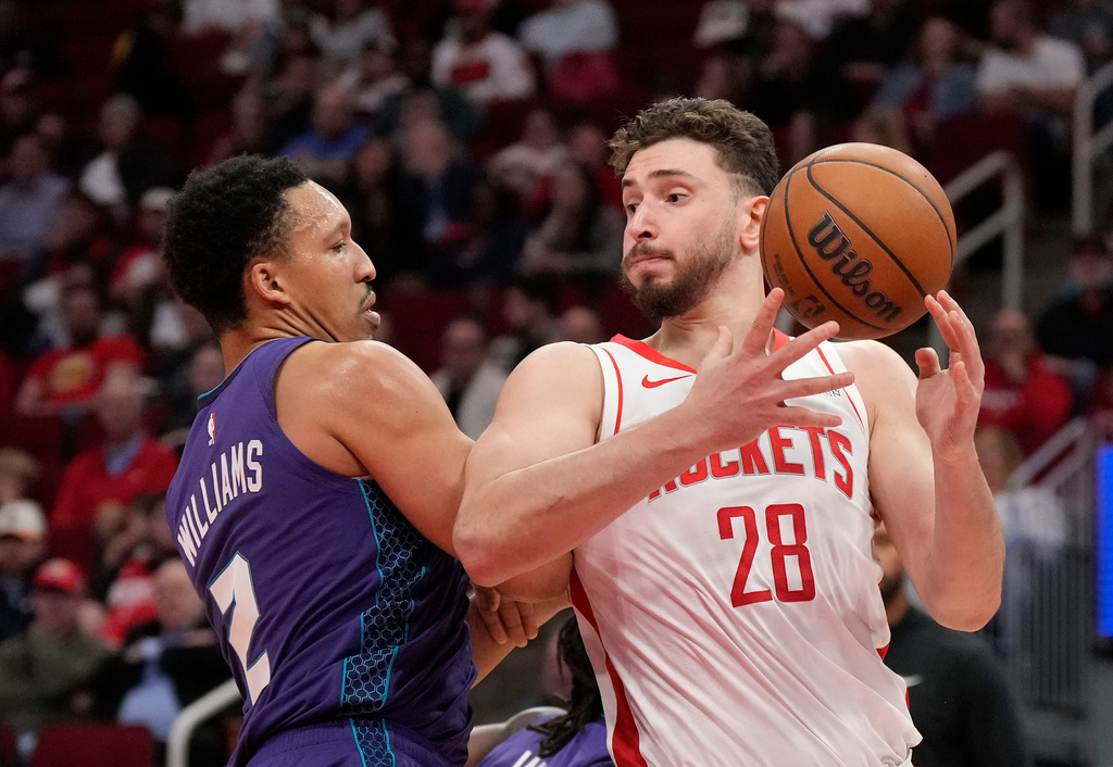 Houston Rockets center Alperen Sengun (28) tries to control the ball against Charlotte Hornets forward Grant Williams (2) during the first half of an NBA basketball game, Thursday, Feb. 5, 2026, in Houston. (AP Photo/ Karen Warren)