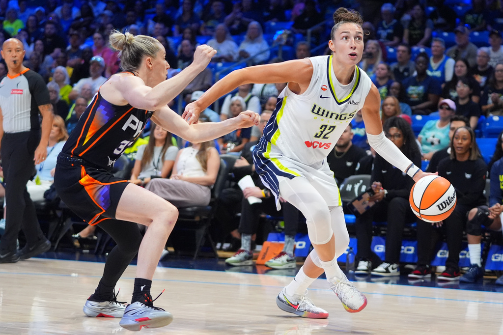Dallas Wings forward Jessica Shepard (32) dribbles against Phoenix Mercury guard Sami Whitcomb (33) during the first half of a WNBA basketball game in Arlington, Texas, Saturday, Sept. 19, 2026. (AP Photo/LM Otero)