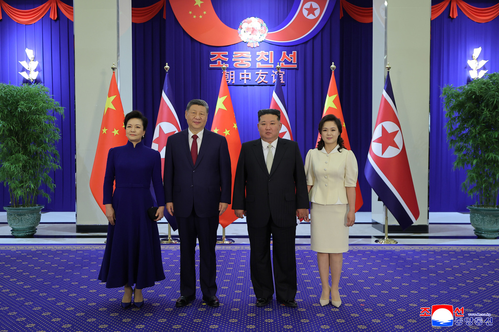 In this photo provided by the North Korean government, North Korean leader Kim Jong Un, center right, and his wife Ri Sol Ju, right, pose with Chinese President Xi Jinping, center left, and his wife Peng Liyuan, left, during a dinner in Pyongyang, Monday, June 8, 2026. Independent journalists were not given access to cover the event depicted in this image distributed by the North Korean government. The content of this image is as provided and cannot be independently verified. Korean language watermark on image as provided by source reads: "KCNA" which is the abbreviation for Korean Central News Agency. (Korean Central News Agency/Korea News Service via AP)