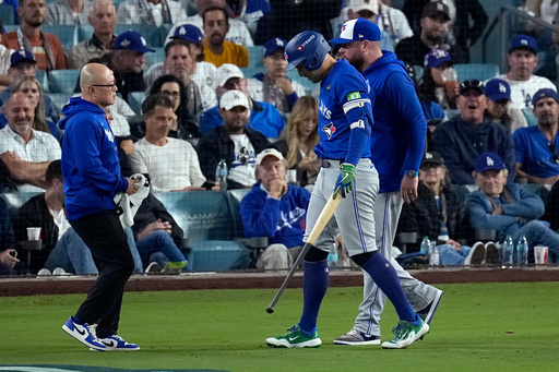 Toronto Blue Jays' George Springer leaves the game with an injury with manager John Schneider, right, during the seventh inning in Game 3 of baseball's World Series against the Los Angeles Dodgers, Monday, Oct. 27, 2025, in Los Angeles. (AP Photo/David J. Phillip) Toronto Blue Jays' George Springer leaves the game with an injury with manager John Schneider, right, during the seventh inning in Game 3 of baseball's World Series against the Los Angeles Dodgers, Monday, Oct. 27, 2025, in Los Angeles. (AP Photo/David J. Phillip)