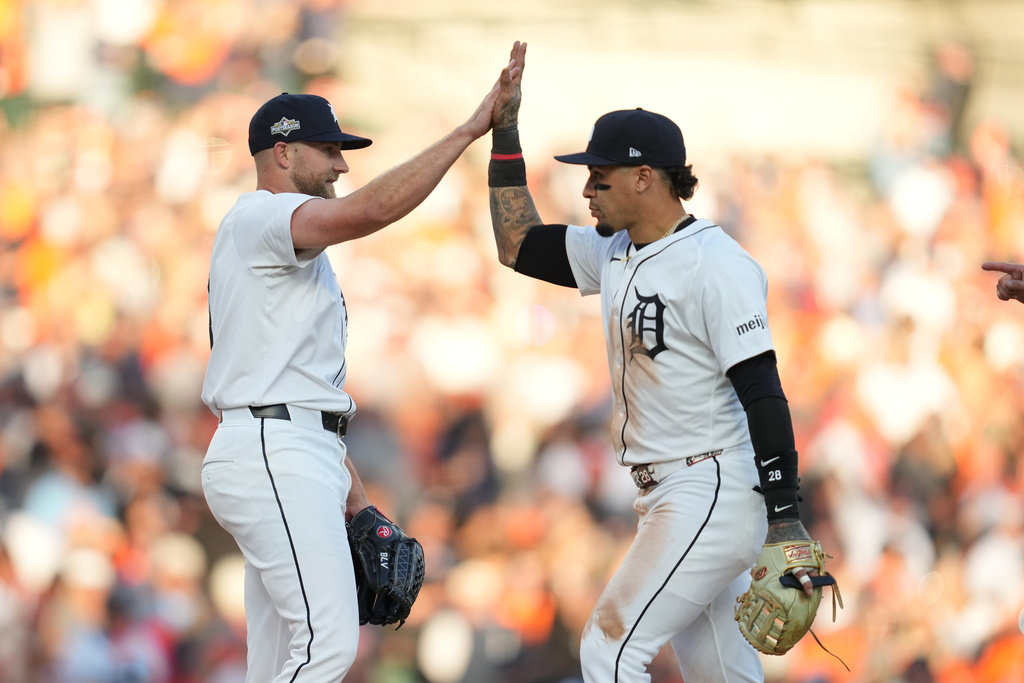 Detroit Tigers' Will Vest and Javier Báez, right, celebrate a victory over the Seattle Mariners in Game 4 of baseball's American League Division Series Wednesday, Oct. 8, 2025, in Detroit. (AP Photo/Paul Sancya)