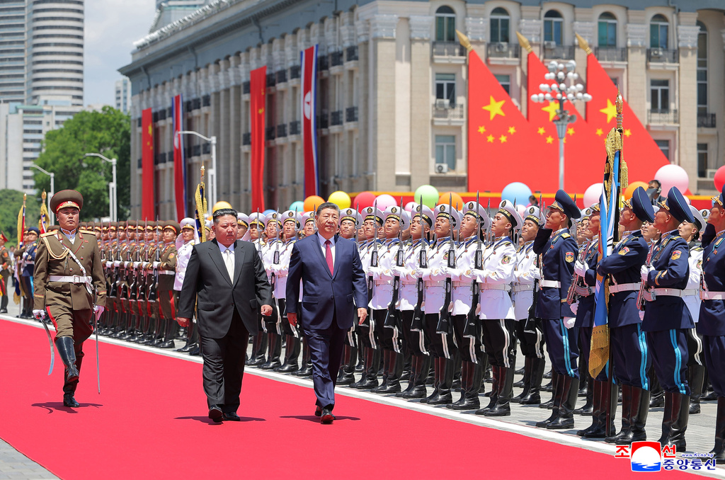 In this photo provided by the North Korean government, Chinese President Xi Jinping, center right, and North Korean leader Kim Jong Un, center left, inspect the honor guard of the Korean People's Army during a welcome ceremony in Pyongyang, Monday, June 8, 2026. Independent journalists were not given access to cover the event depicted in this image distributed by the North Korean government. The content of this image is as provided and cannot be independently verified. Korean language watermark on image as provided by source reads: "KCNA" which is the abbreviation for Korean Central News Agency. (Korean Central News Agency/Korea News Service via AP)