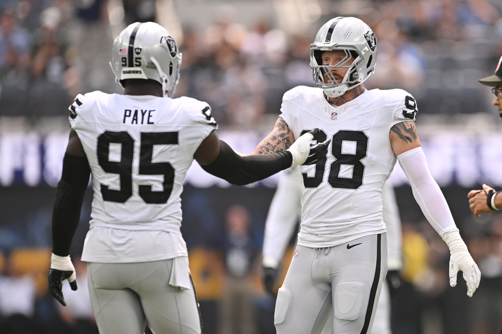 Las Vegas Raiders defensive end Maxx Crosby (98) and defensive end Kwity Paye (95) shake hands after a defensive stop during the first half an NFL football game against the Los Angeles Chargers in Inglewood, Calif., Sunday, Sept. 20, 2026. (AP Photo/Katie Chin)
