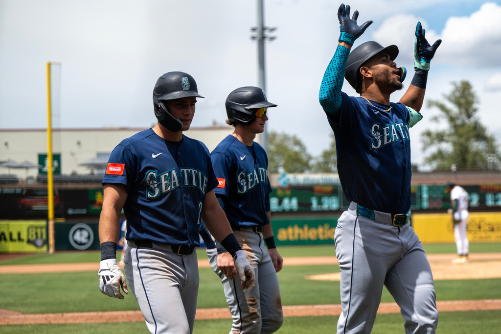Seattle Mariners' Julio Rodríguez celebrates after hitting a home run during the eighth inning of a baseball game against the Athletics in West Sacramento, Calif., Wednesday, May 27, 2026. (AP Photo/Nic Coury)