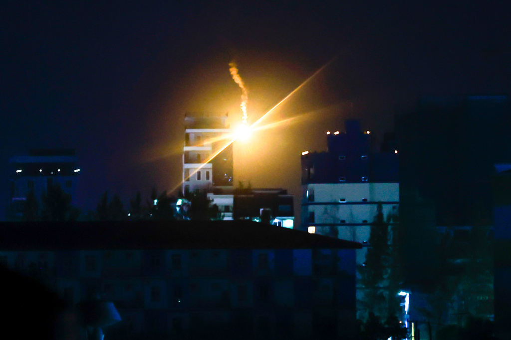 Illumination flares fired by Thai military forces shine in Poipet, Cambodia, as seen from Sa Kaeo, Thailand, on Friday, Dec. 26, 2025, following clashes between Thai and Cambodian soldiers. (AP Photo/Wason Wanichakorn)