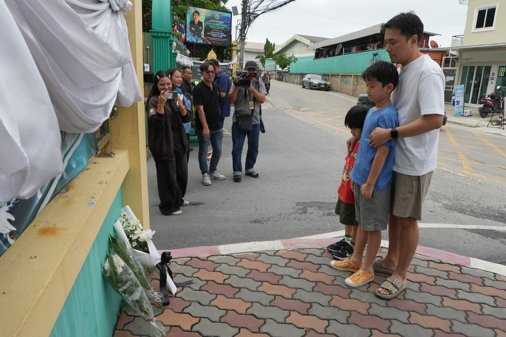 People offer prayers at the gate of Debsirin Nonthaburi School, a day after the shooting at the school in Nonthaburi province, Thailand, Saturday, Aug. 8, 2026. (AP Photo/Sakchai Lalit)