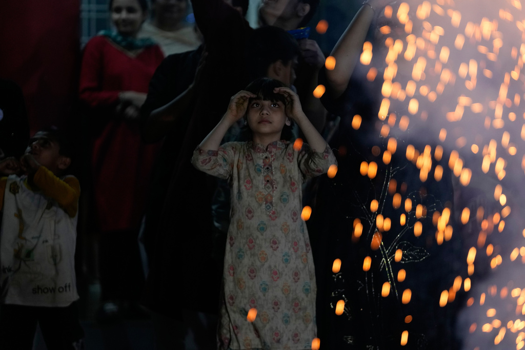 Children play with firecrackers on Diwali festival, the Hindu festival of lights, at an orphanage in Jammu, India, Sunday, Oct.19, 2025.(AP Photo/Channi Anand)