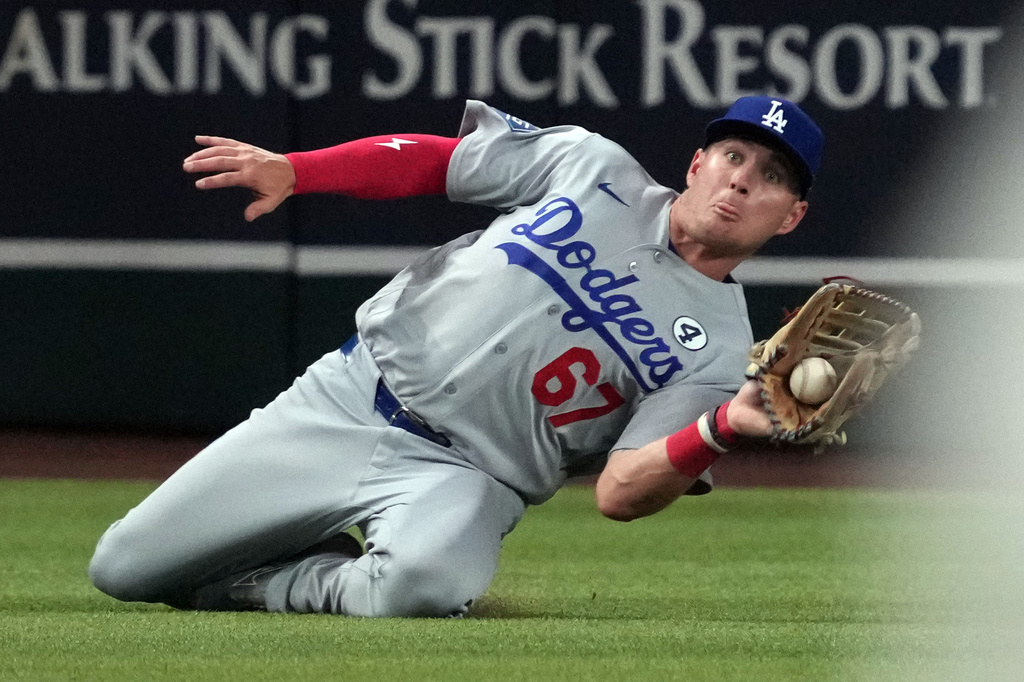 Los Angeles Dodgers left fielder Ryan Ward makes the sliding catch for an out on a ball hit by Arizona Diamondbacks' Nolan Arenado in the fifth inning of a baseball game, Tuesday, June 2, 2026, in Phoenix. (AP Photo/Rick Scuteri)