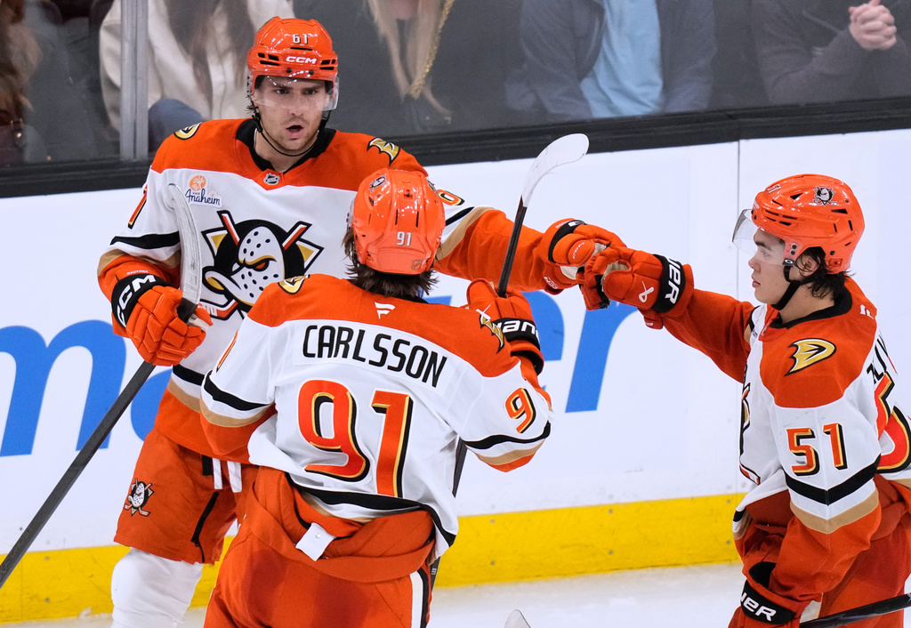 Anaheim Ducks left wing Cutter Gauthier, left, is congratulated after his goal against the Boston Bruins during the second period of an NHL hockey game, Thursday, Oct. 23, 2025, in Boston. (AP Photo/Charles Krupa)