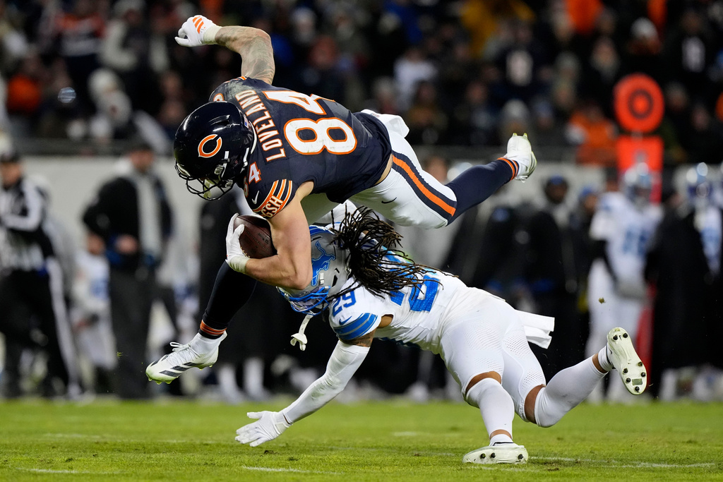 Chicago Bears tight end Colston Loveland (84) is tackled by Detroit Lions cornerback Avonte Maddox (29) during the second half of an NFL football game, Sunday, Jan. 4, 2026, in Chicago. (AP Photo/Nam Y. Huh)