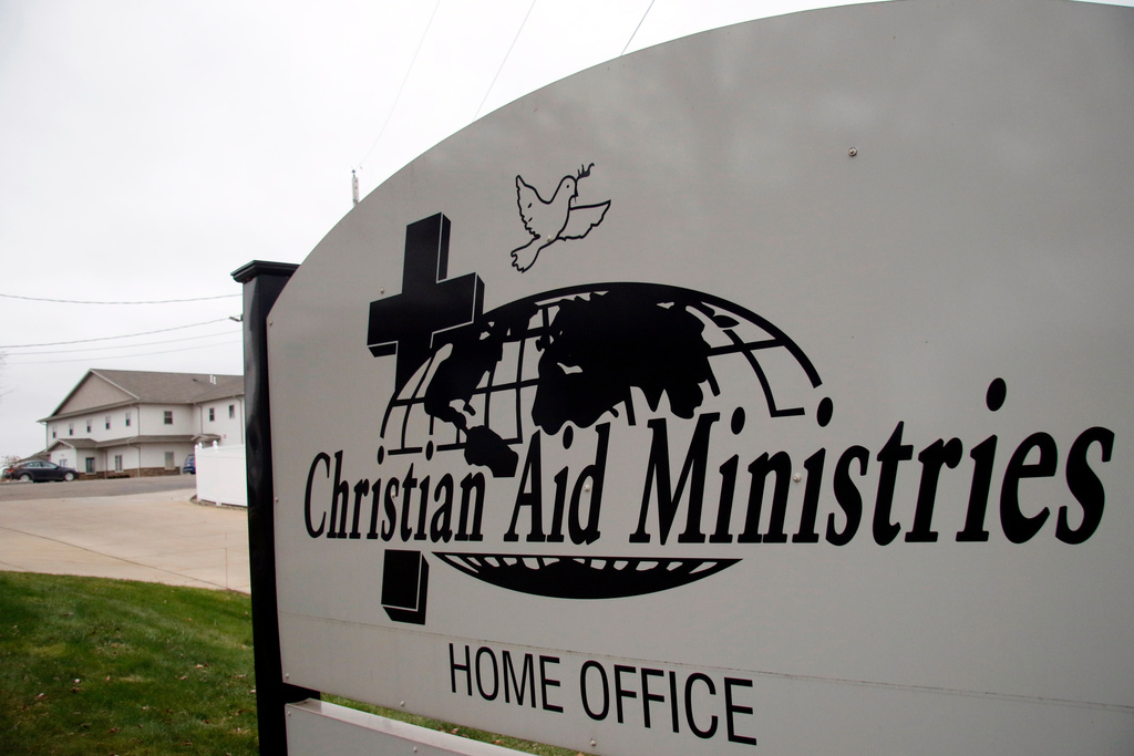 FILE - A sign for the Christian Aid Ministries offices is seen in Berlin, Ohio, Dec. 16, 2021. (AP Photo/Tom E. Puskar, File)