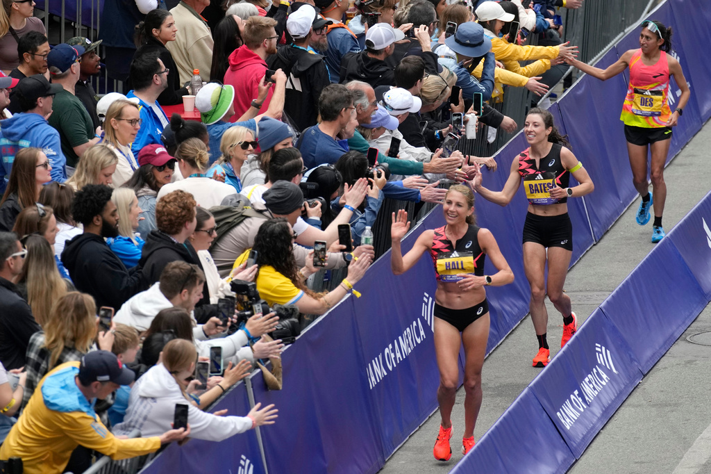 FILE - American women finishers celebrate with the crowd at the Boston Marathon, April 15, 2024, in Boston. At right are Sara Hall, Emma Bates and Des Linden. (AP Photo/Charles Krupa, File)