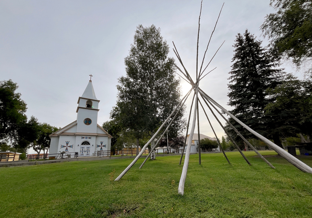 The frame of a teepee is displayed outside the St. Stephens Indian Mission Catholic church in Arapahoe, Wyo., on Monday, Aug. 17, 2026. (AP Photo/Thomas Peipert)