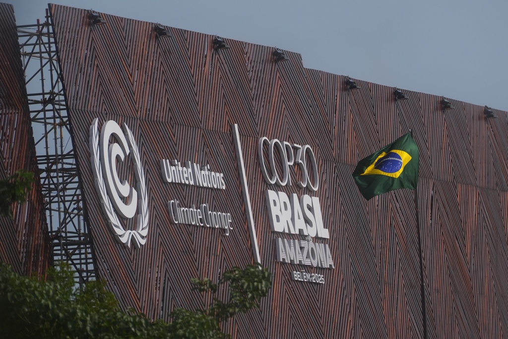 A Brazilian flag flies outside the venue for the COP30 U.N. Climate Summit, Thursday, Nov. 13, 2025, in Belem, Brazil. (AP Photo/Joshua A. Bickel)