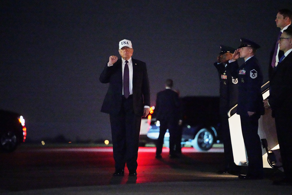 President Donald Trump holds up a fist after disembarking Air Force One at Palm Beach International Airport in West Palm Beach, Fla., Friday, Feb. 27, 2026. (AP Photo/Matt Rourke)