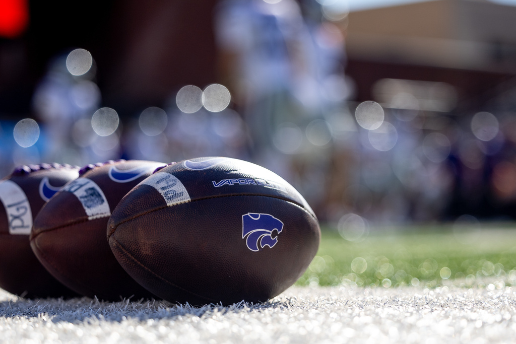 FILE - Kansas State footballs sit on the sideline before an NCAA college football game against Oklahoma State, Nov. 15, 2025, in Stillwater, Okla. (AP Photo/Mitch Alcala, File)
