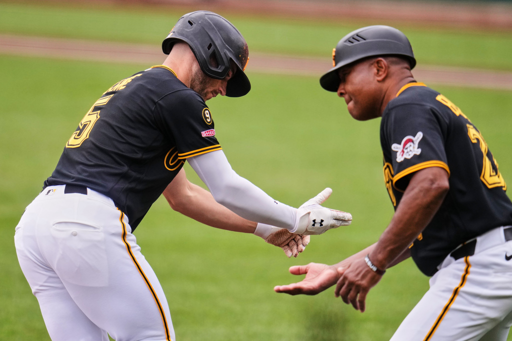 Pittsburgh Pirates' Brandon Lowe, left, is greeted by third base coach Tony Beasley as he rounds third base after hitting a solo home run off Seattle Mariners pitcher Bryce Miller during the first inning of a baseball game in Pittsburgh, Thursday, June 25, 2026. (AP Photo/Gene J. Puskar)