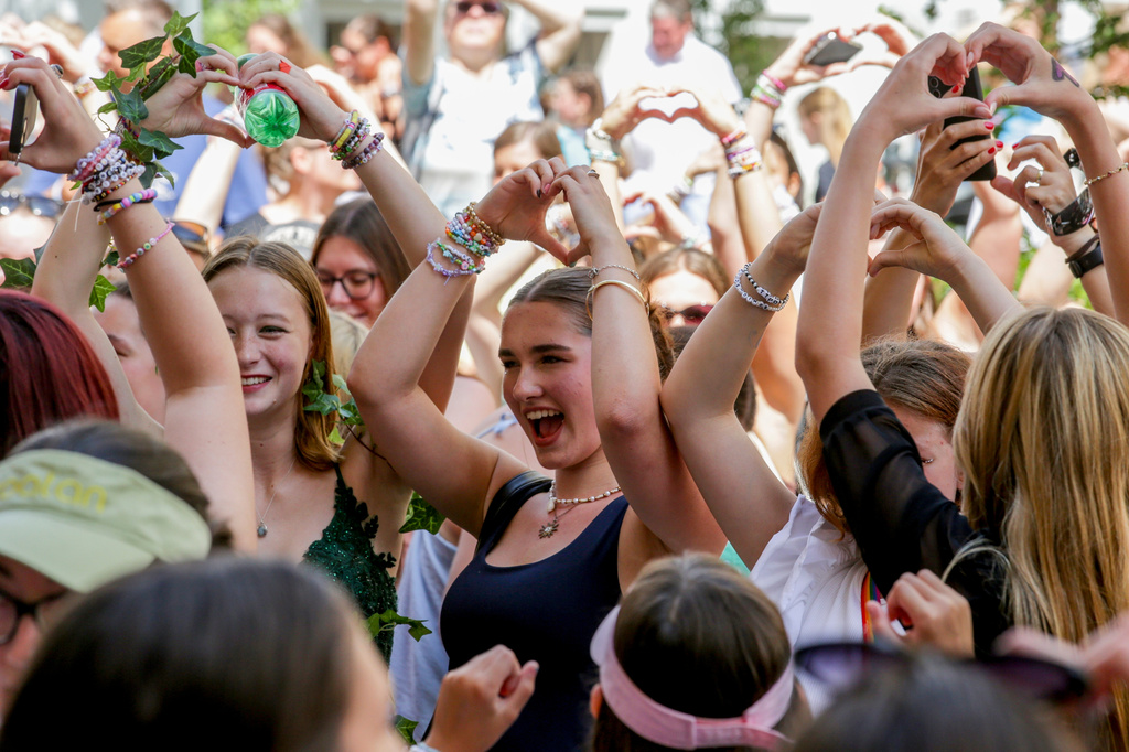 FILE - Fans of Taylor Swift also known as Swifties sing and dance in Vienna, Aug.9, 2024. (AP Photo/Heinz-Peter Bader, File)