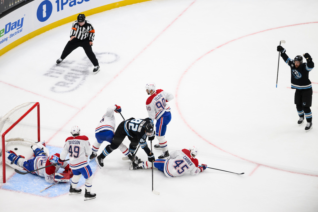 Utah Mammoth left wing Michael Carcone, right, celebrates scoring a goal during the second period of an NHL hockey game against the Montréal Canadiens, Wednesday, Nov. 26, 2025, in Salt Lake City. (AP Photo/Tyler Tate)