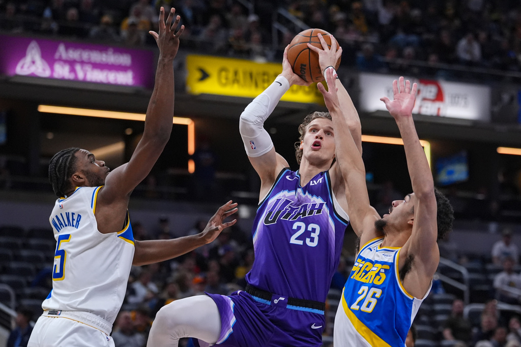 Utah Jazz forward Lauri Markkanen (23) shoots between Indiana Pacers forward Jarace Walker (5) and guard Ben Sheppard (26) during the second half of an NBA basketball game in Indianapolis, Tuesday, Feb. 3, 2026. (AP Photo/Michael Conroy)