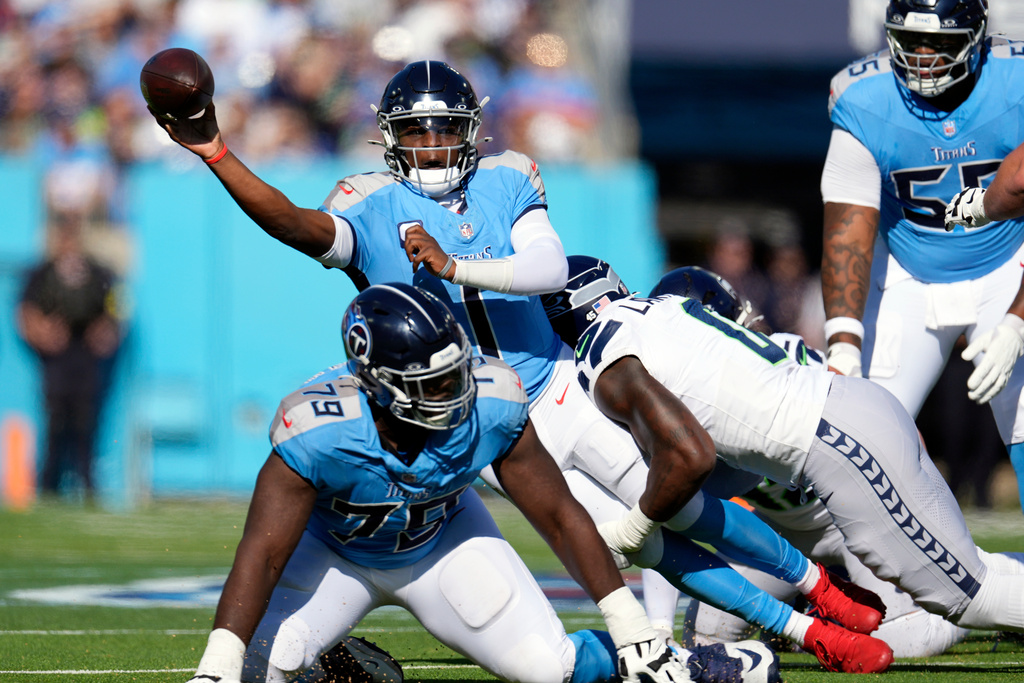 Tennessee Titans quarterback Cam Ward (1) gets a completed pass away during the first half of an NFL football game against the Seattle Seahawks Sunday, Nov. 23, 2025, in Nashville, Tenn. (AP Photo/George Walker IV)