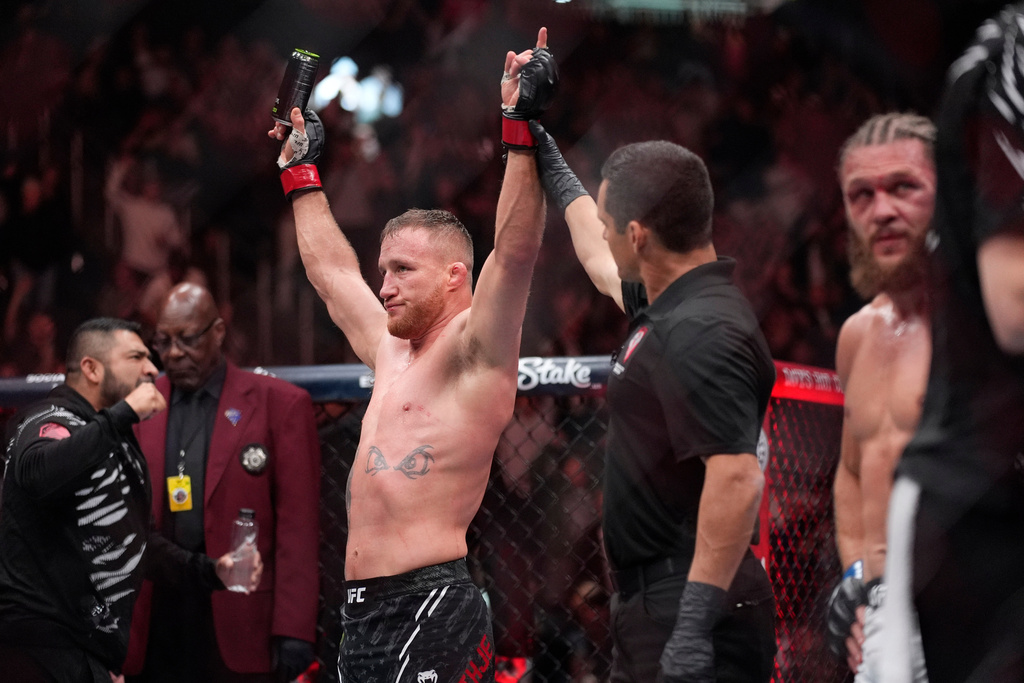 FILE - Justin Gaethje, left, celebrates after defeating Rafael Fiziev in a UFC 313 mixed martial arts lightweight bout, March 8, 2025, in Las Vegas. (AP Photo/John Locher, File)