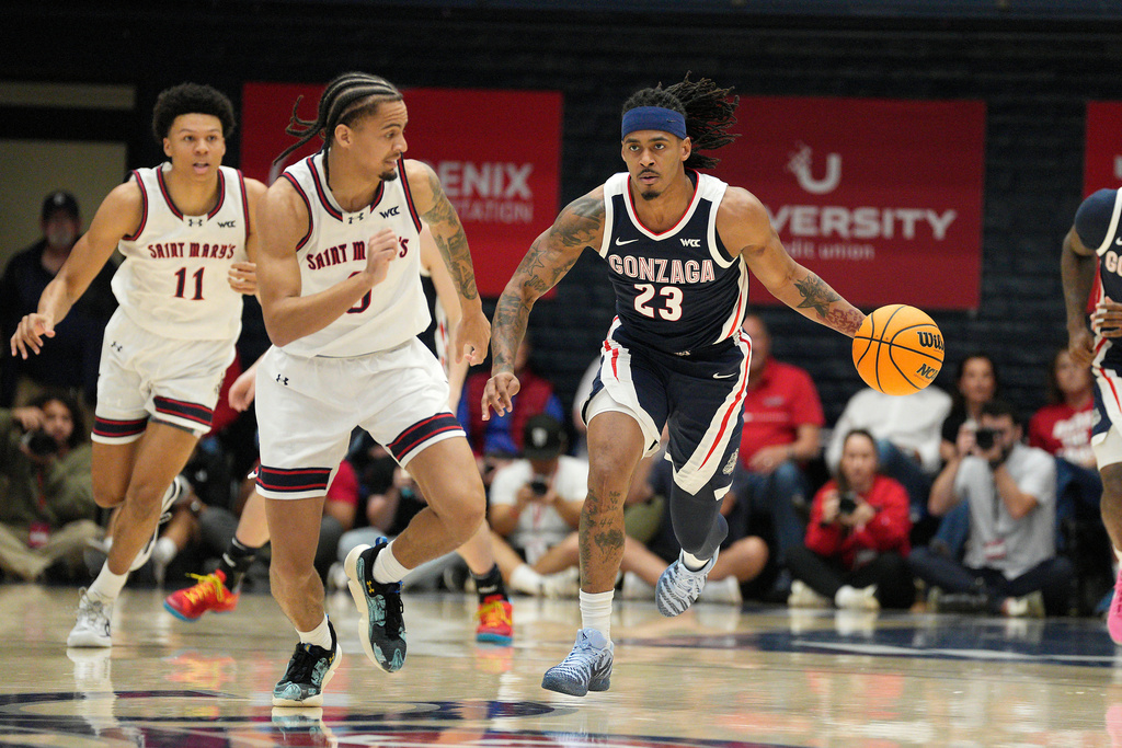 Gonzaga guard Adam Miller (23) dribbles down court against Saint Mary's guard Mikey Lewis (0) during the first half of an NCAA college basketball game in Moraga, Calif., Saturday, Feb. 28, 2026. (AP Photo/Tony Avelar)
